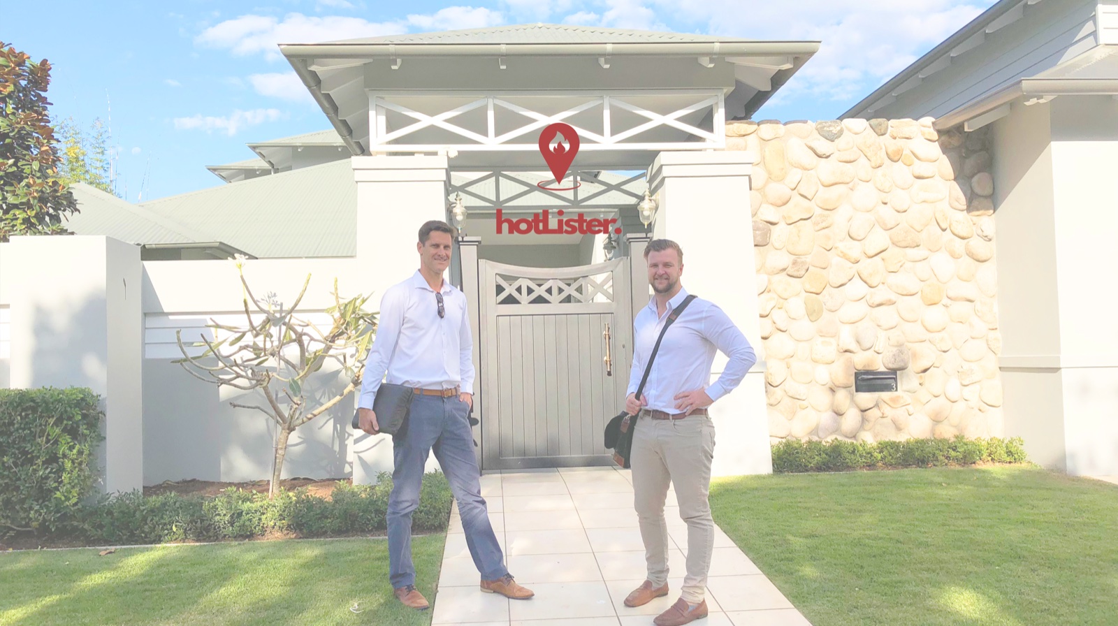 hotLister agents in front of a property